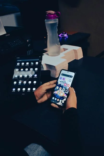 Smartphone showing communication icons for call, email, and messaging on screen.
